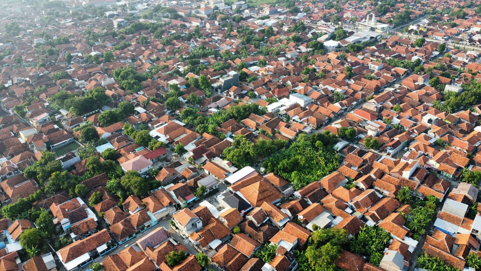 an aerial view of a city with red roofs